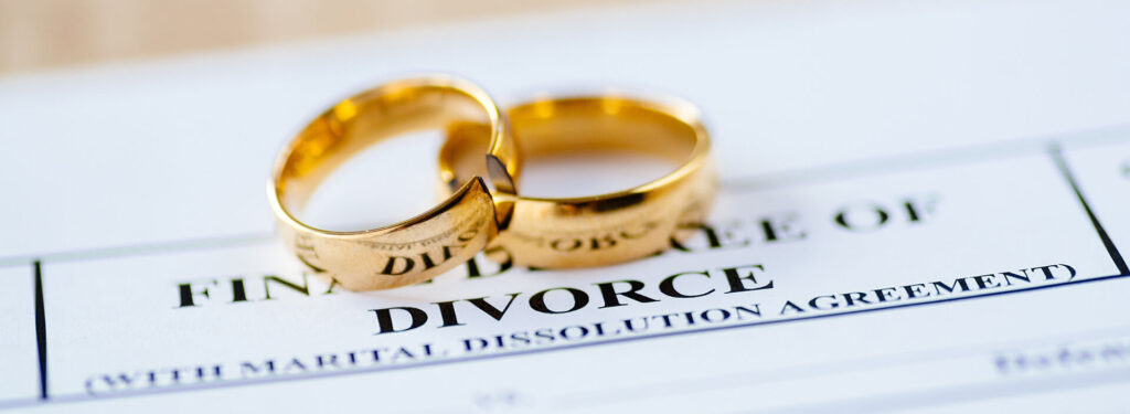 Divorce Paperwork with wedding rings on top.